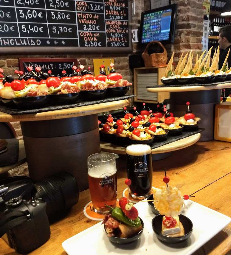 Pintxos and drinks on a restaurant counter in Barcelona
